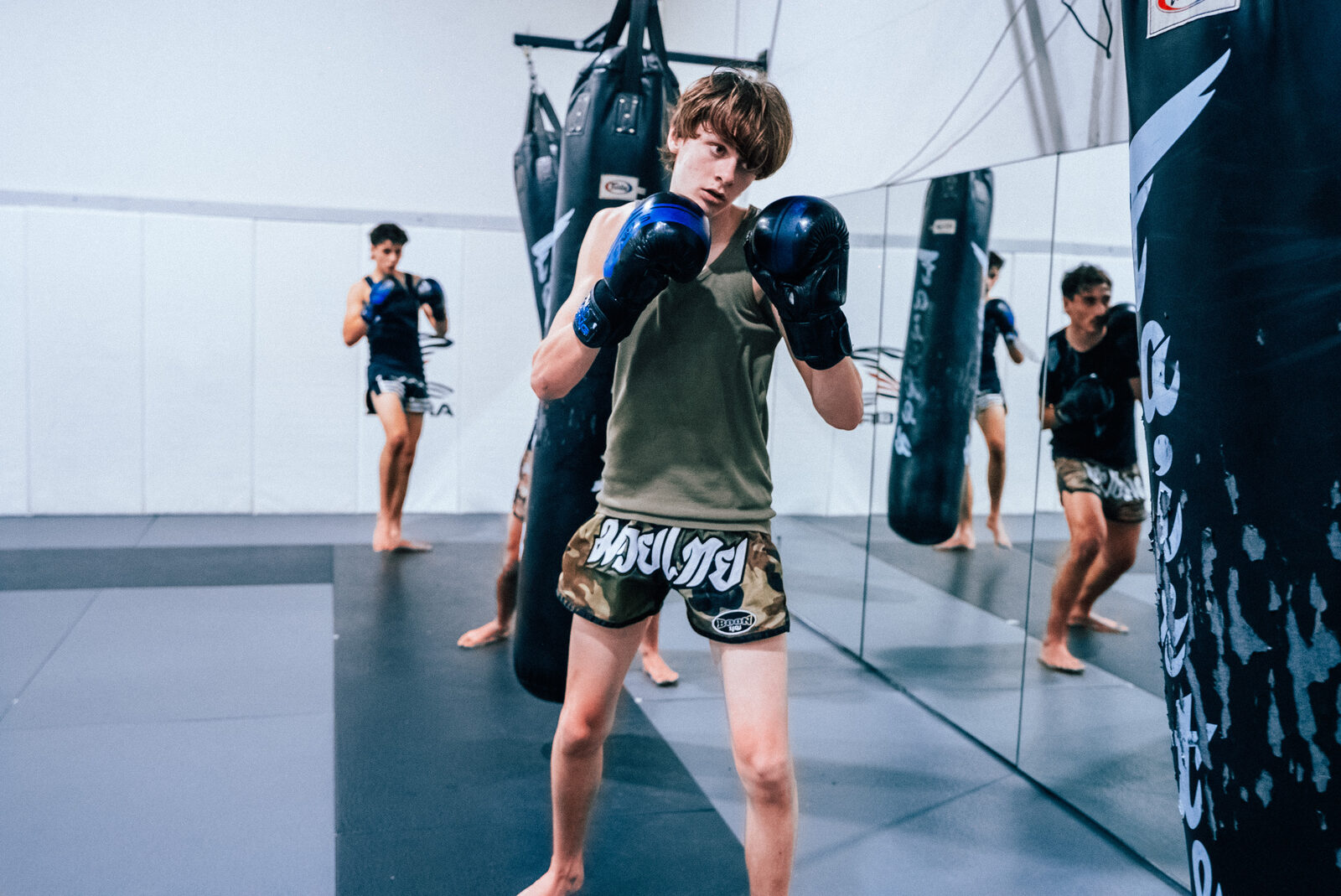 Student setting his stance on the heavy bag