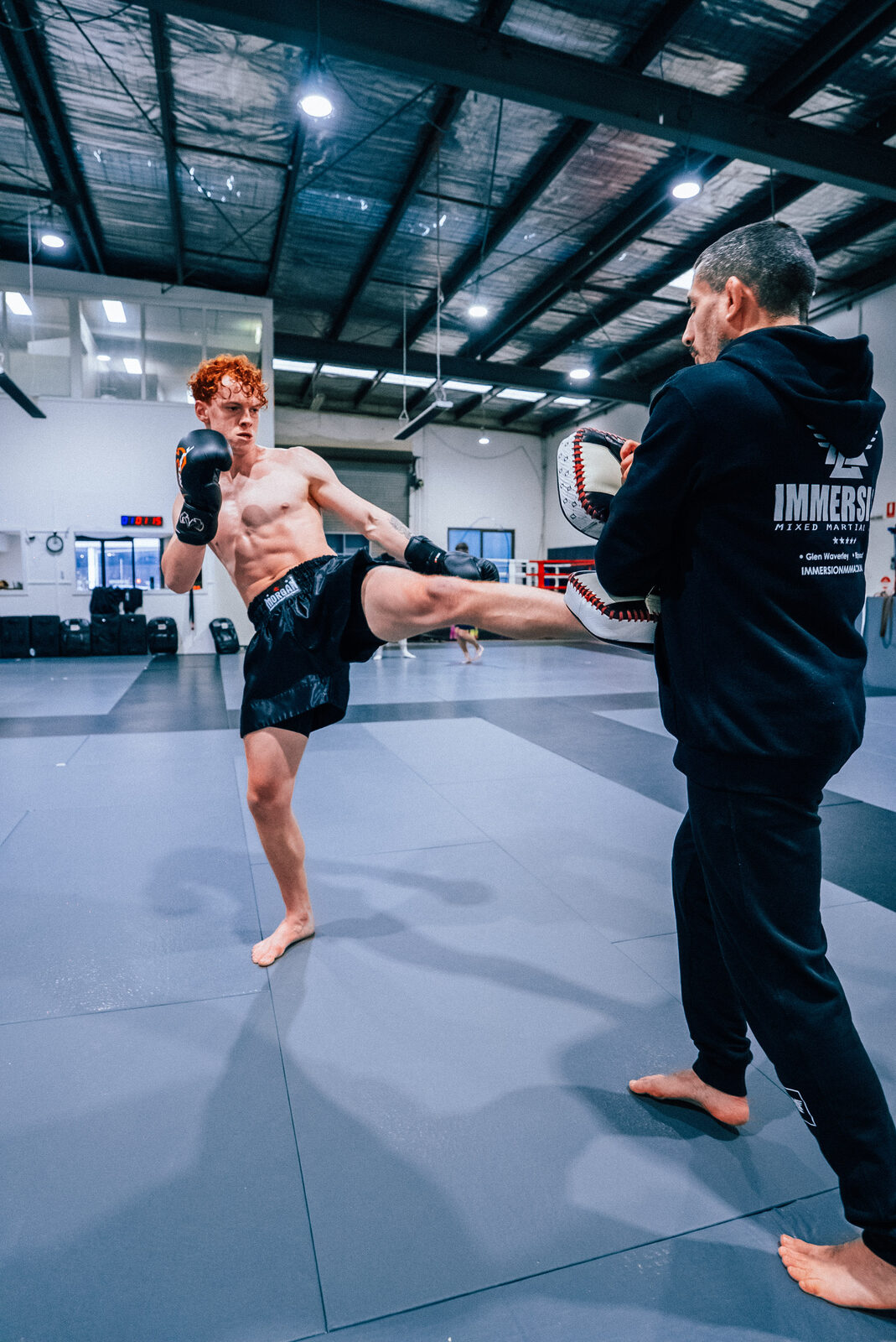 Student turning a kick over into the coaching pad