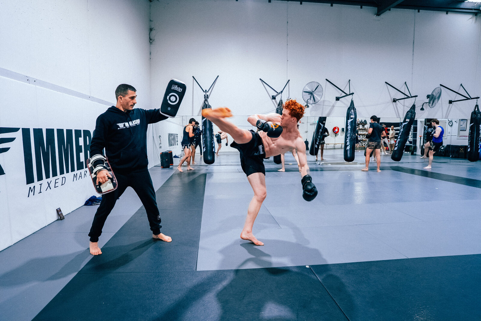Roundhouse kick into the pads during a K1 round