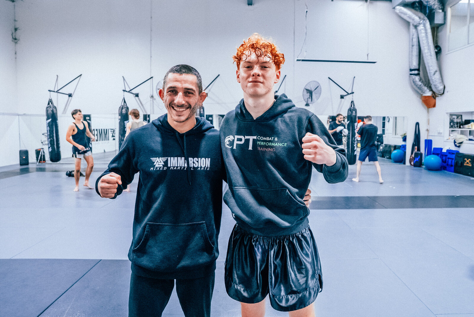 Sotir Kichukov with a student in a CPT hoodie after training