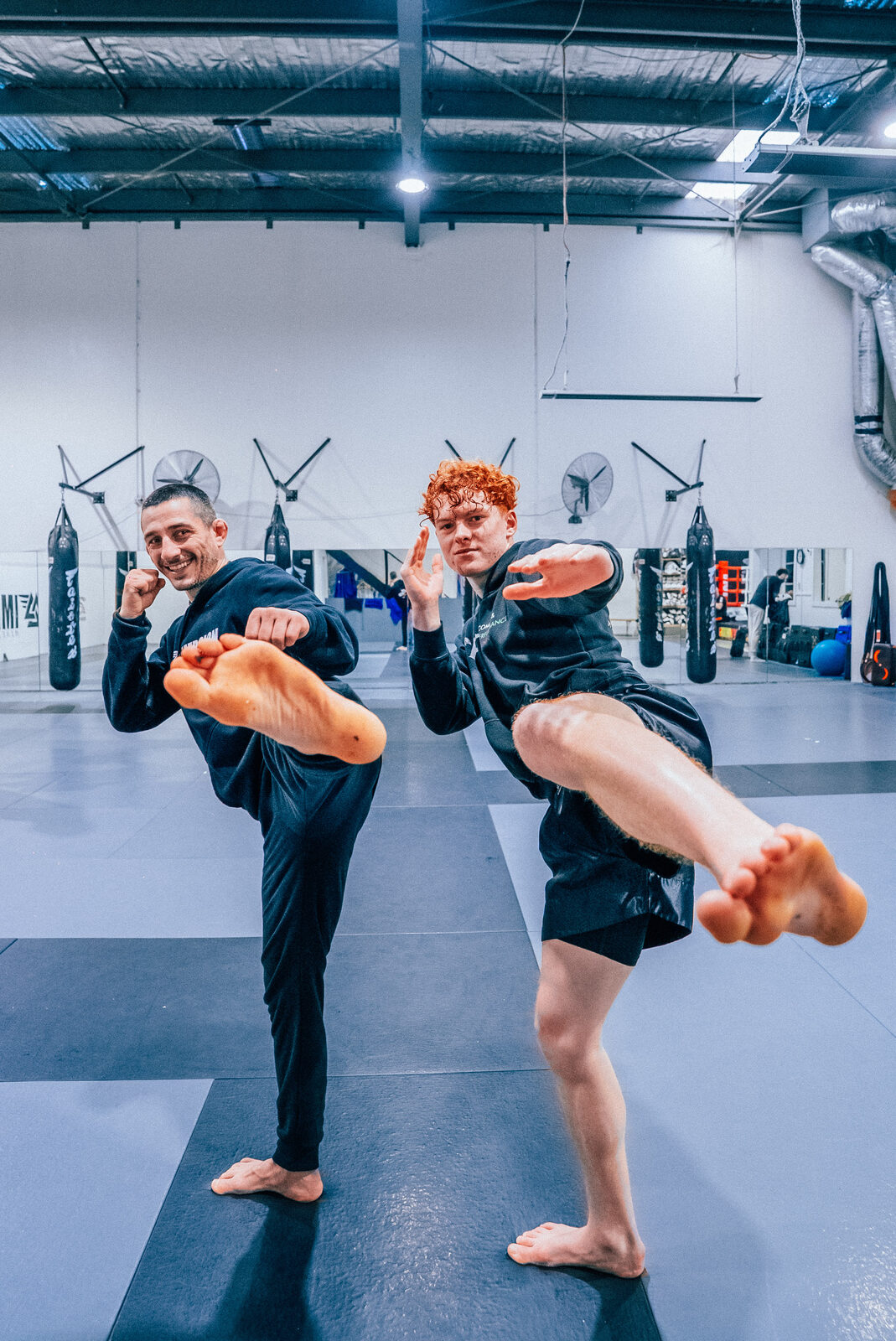 Sotir Kichukov and a student mirroring a kick after class
