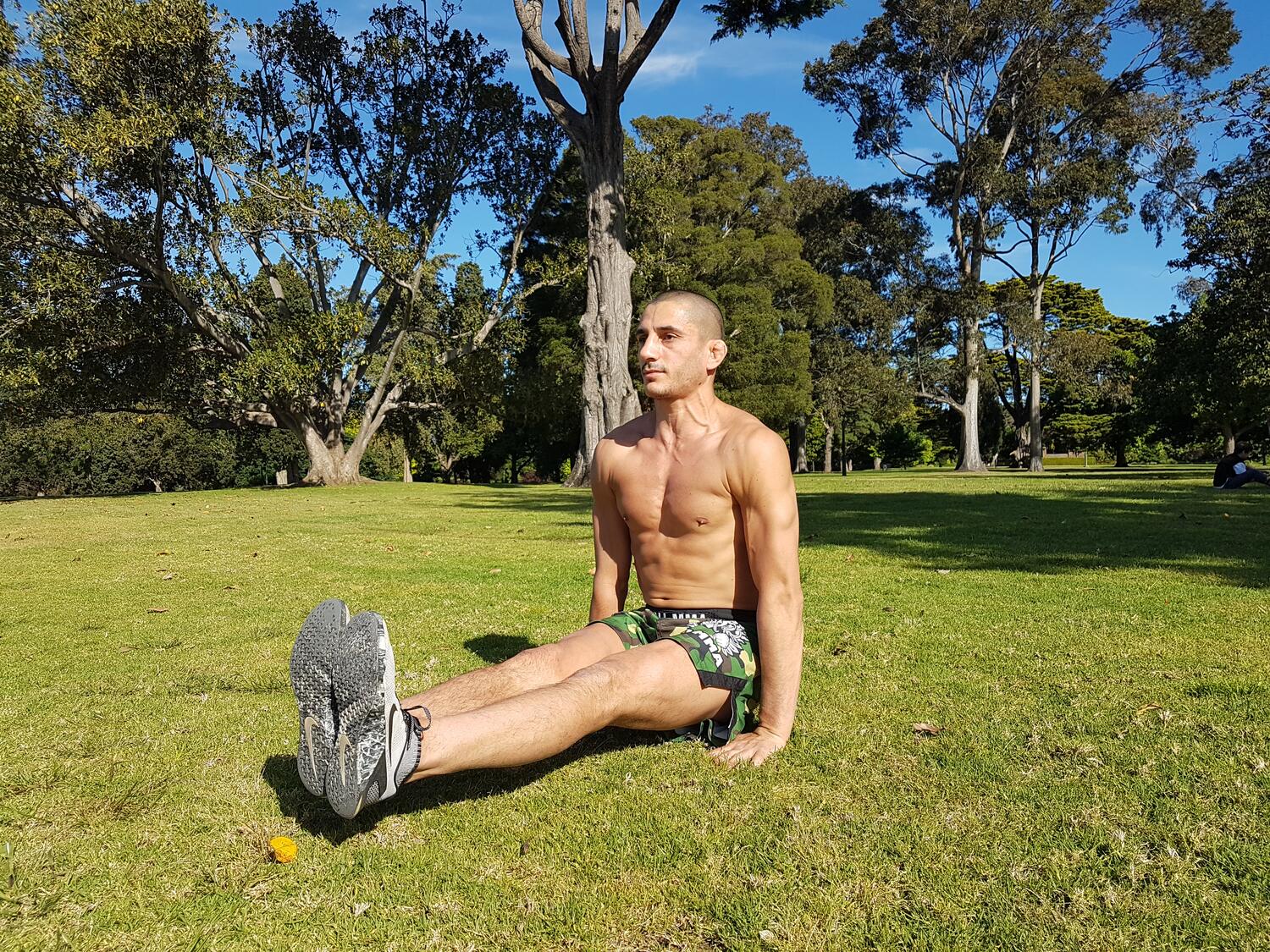 Sotir Kichukov stretching on the grass between sprint sets